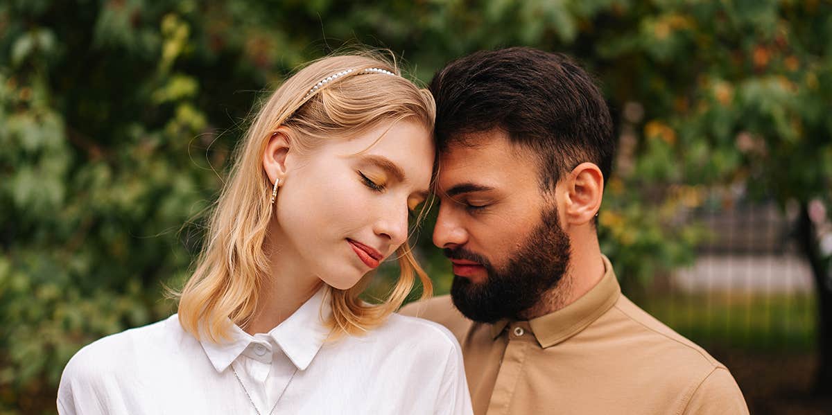 man and woman embracing with eyes closed