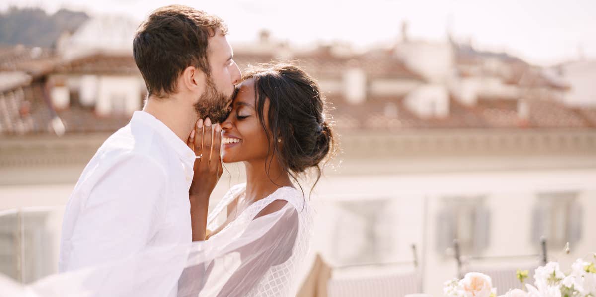 man kissing woman's face