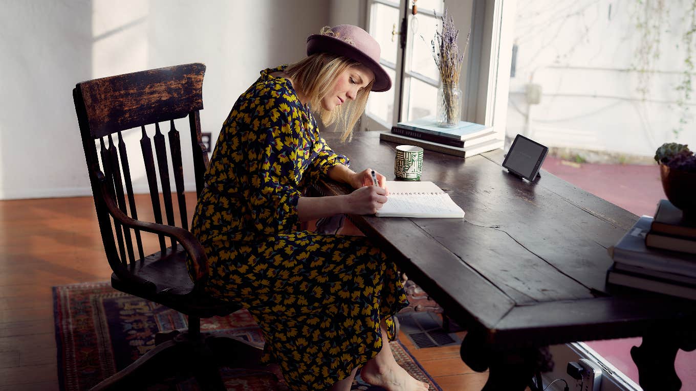 woman writing at a desk