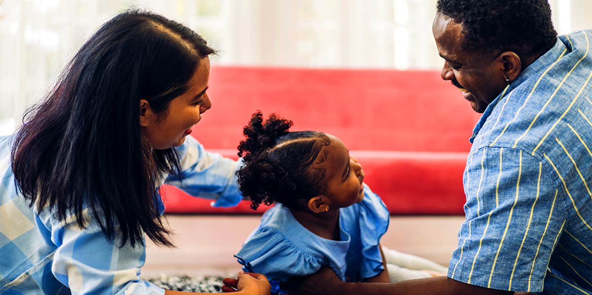 parents playing with young daughter