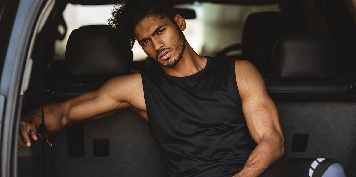 attractive fit man sitting in back of car