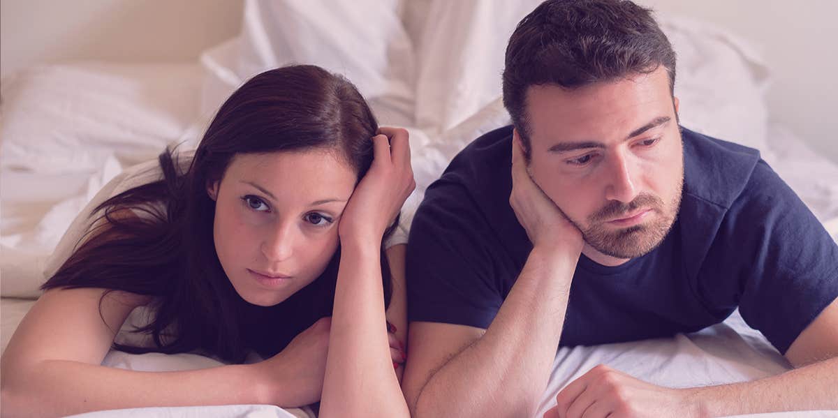 The 2 Main Reasons Your Boring Married Sex Is Still Boring couple looks boarded on bed
