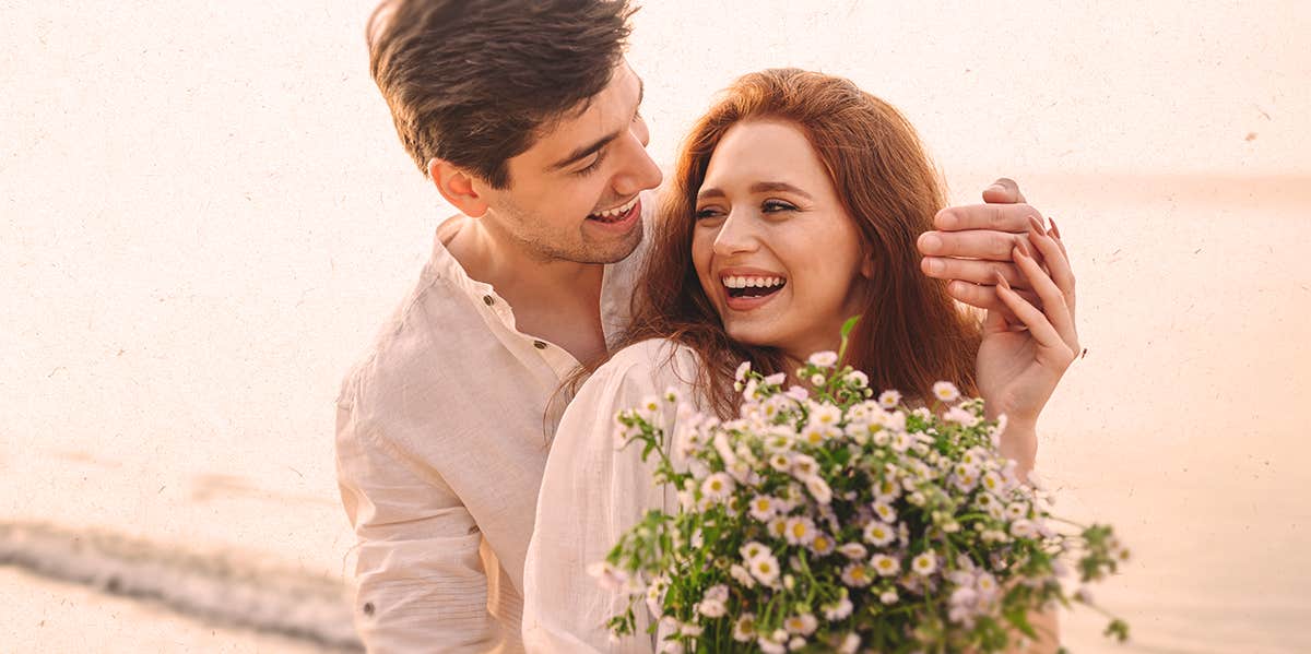 couple hugging, woman holding flower