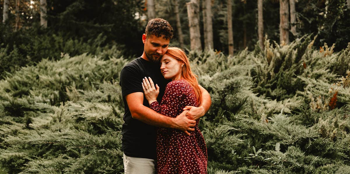 20 Powerful Things to Say to a Woman Whose Love Language is Words of man hugging woman in forest