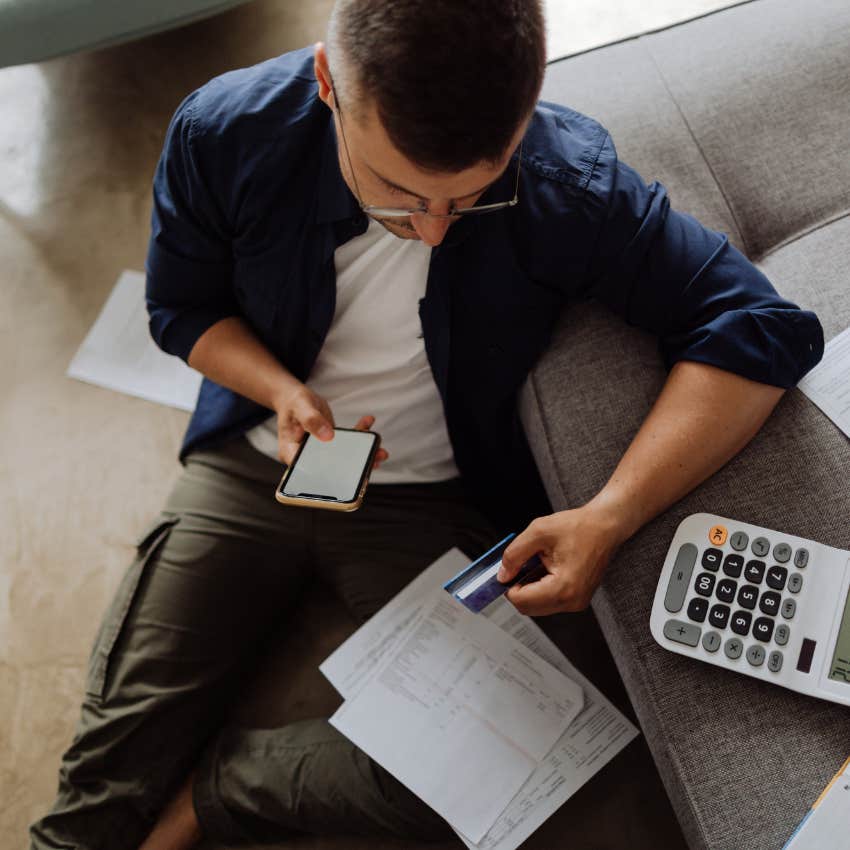 man paying bills with credit card