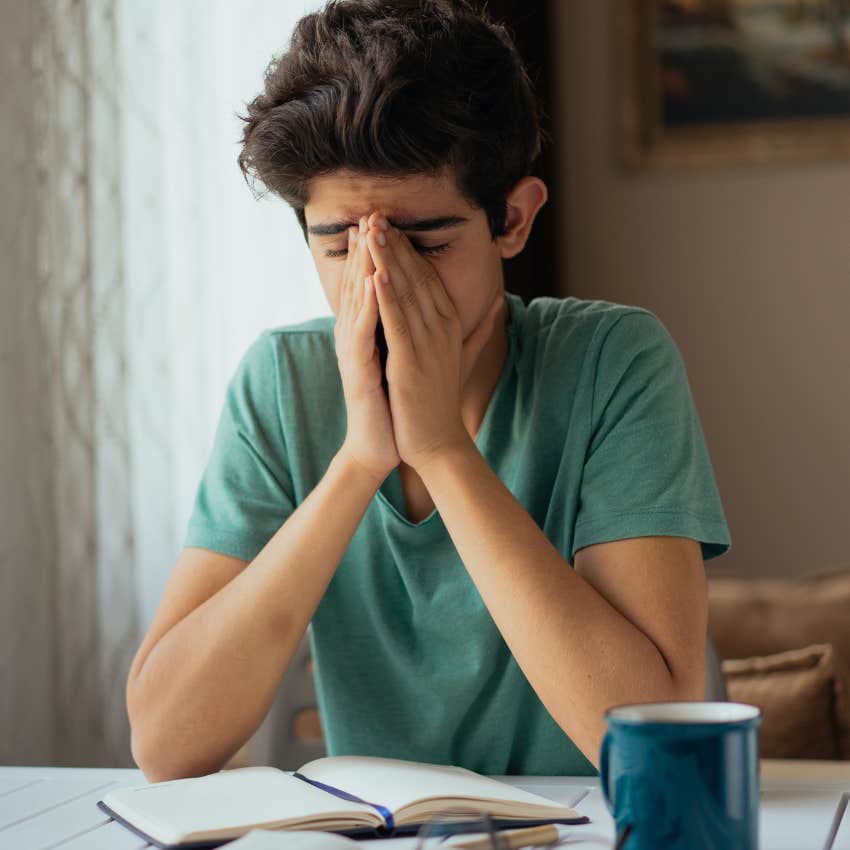 Young student looking frustrated at desk. 