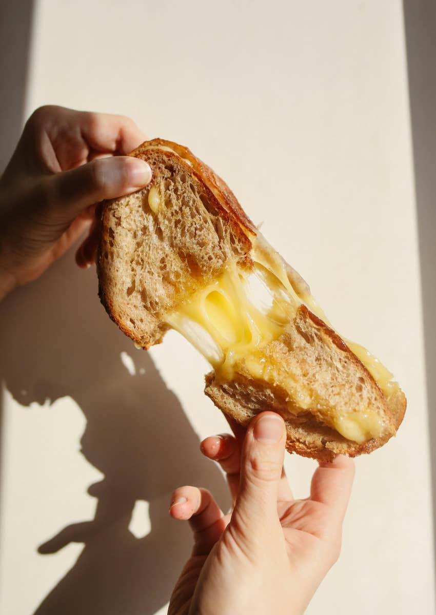 kid holding grilled cheese sandwich