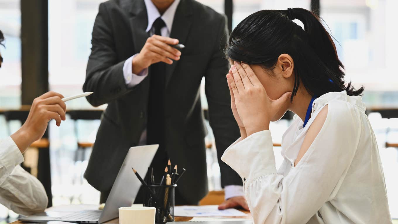 Harvard Business Experts Reveal What To Do If You Hate Your Boss Worker looking frustrated in a room with her boss.