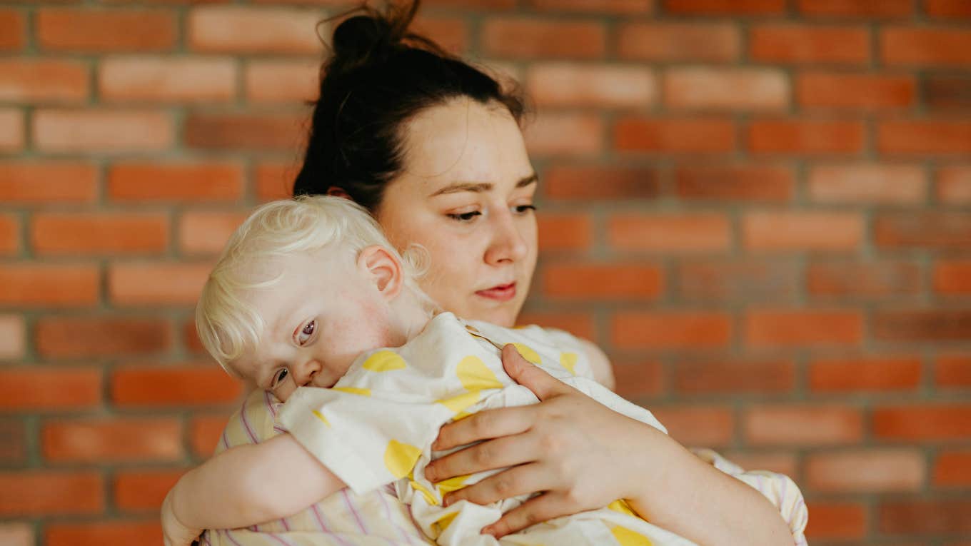Husband Sets August Deadline For His Postpartum Wife To Lose 50 Pounds woman holding a baby