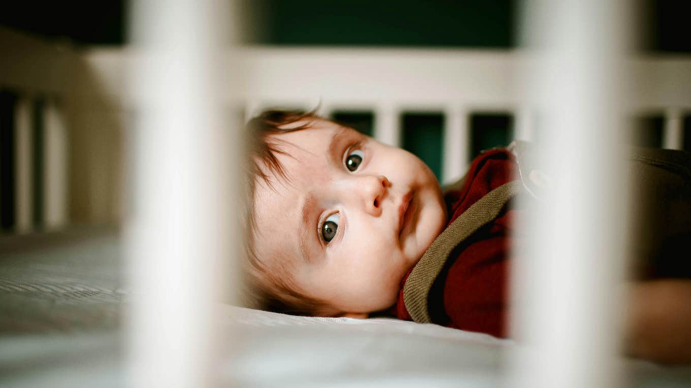 baby laying awake in a crib