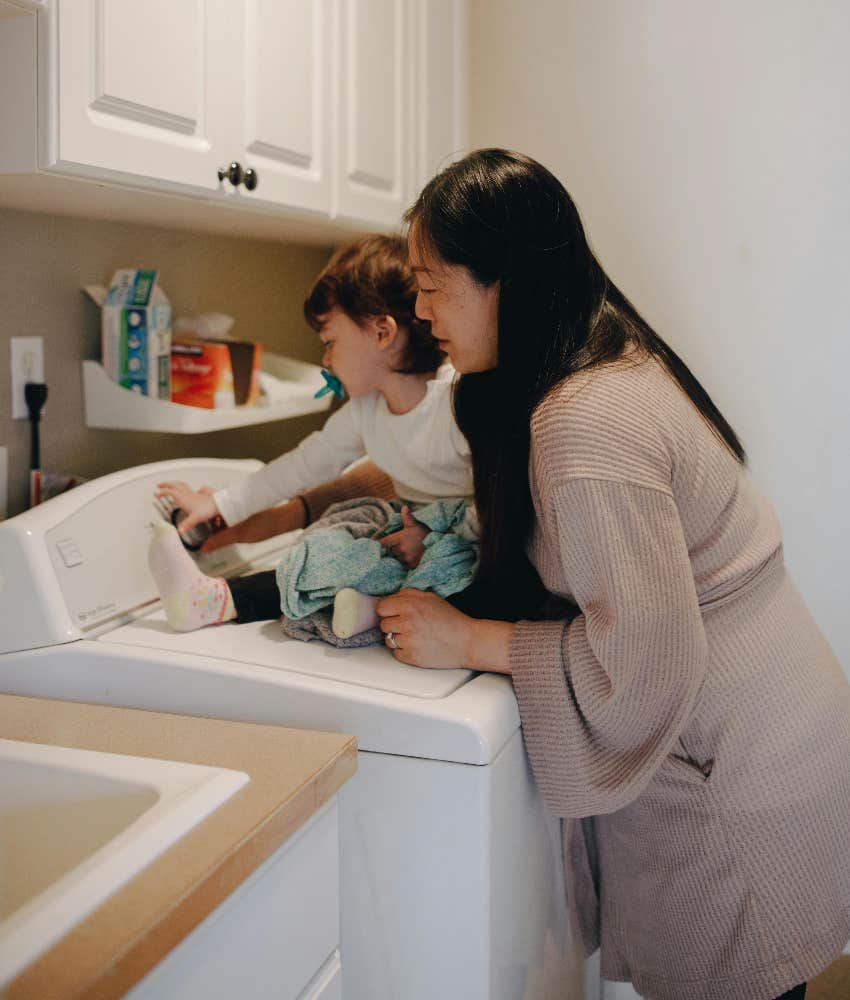 mom doing chores with child