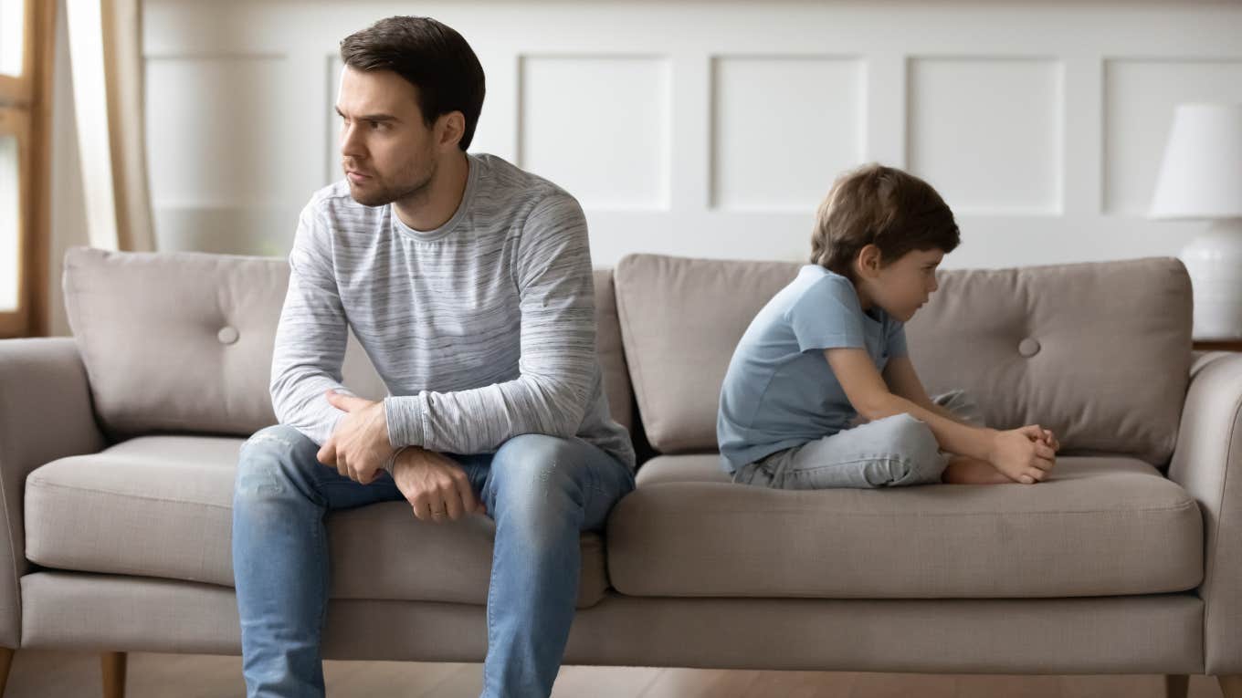 upset father and son sitting on couch