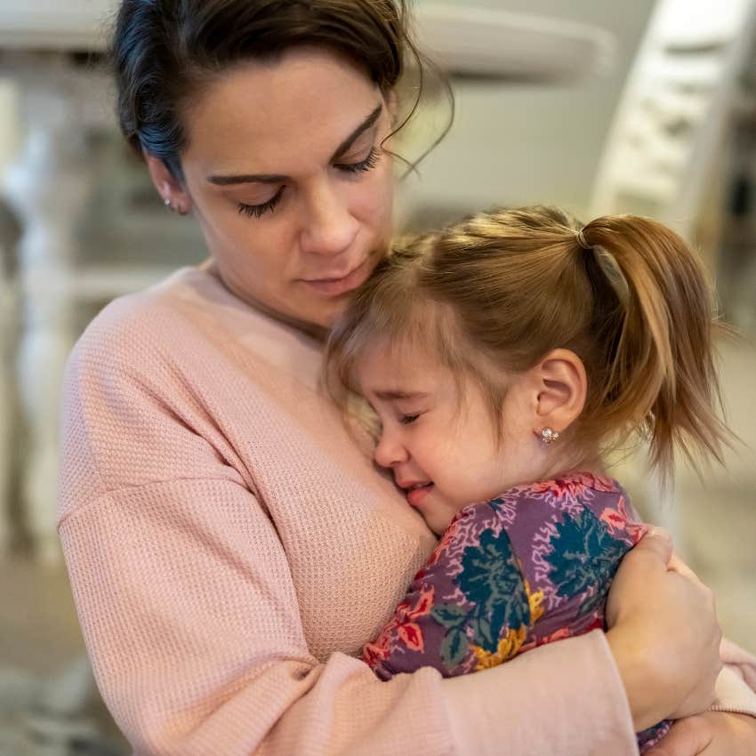 mom comforting daughter