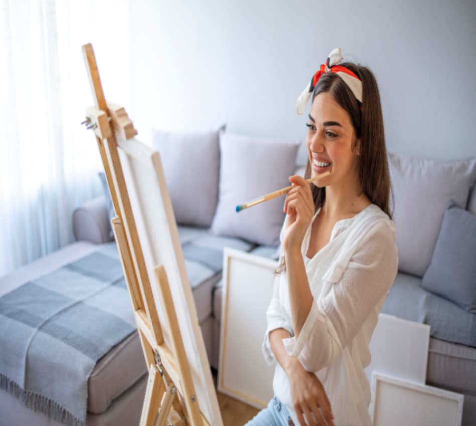 woman painting and smiling