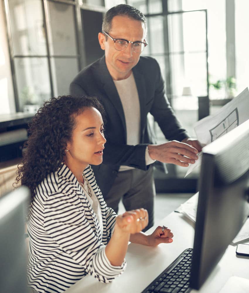 man and woman looking at computer 