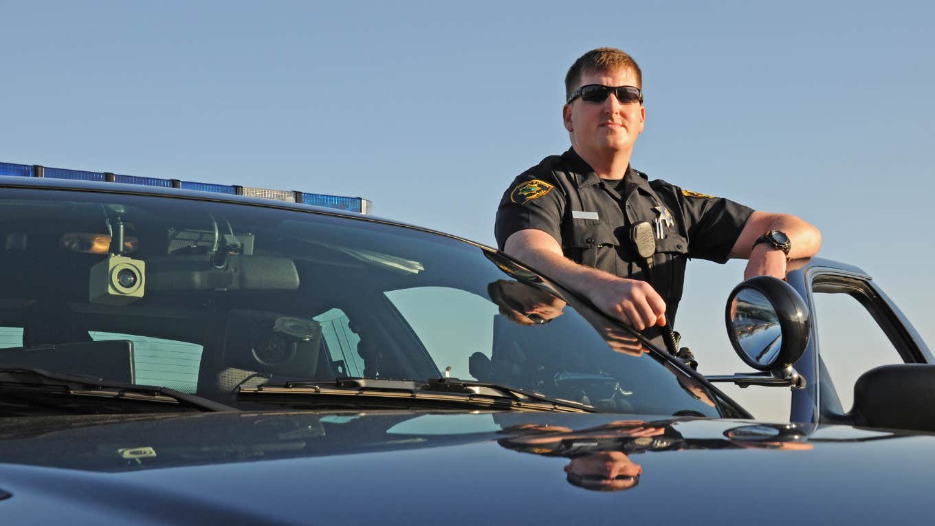 police officer standing outside squad car