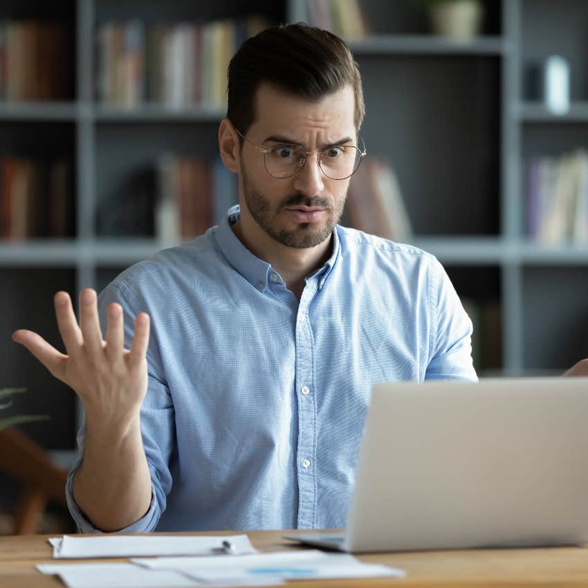 man on computer upset after finding his job posted for more pay