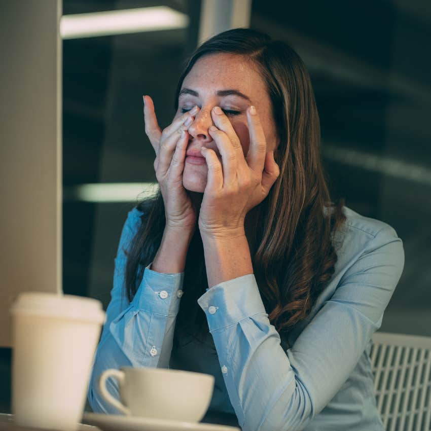 Worker looking stressed on her computer. 