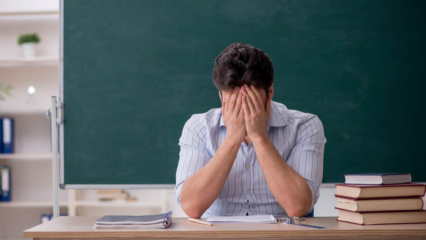 Teacher Has To Take Half Day After His Students Misbehave frustrated teacher with head in his hands