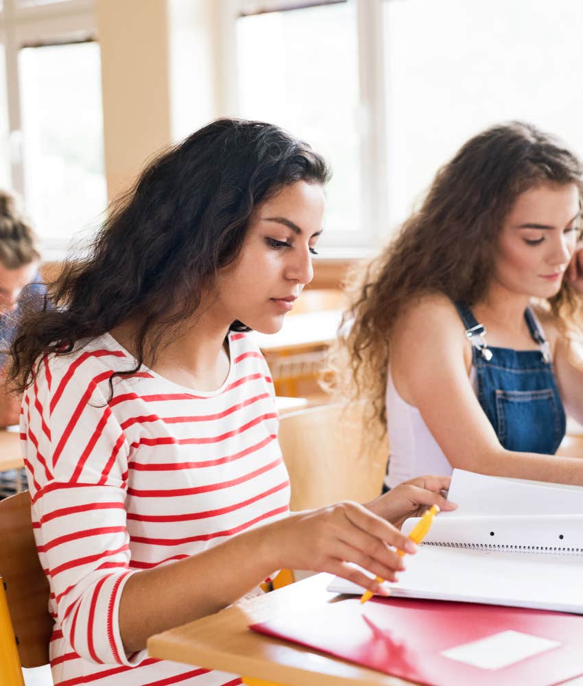 teen girl reading in class