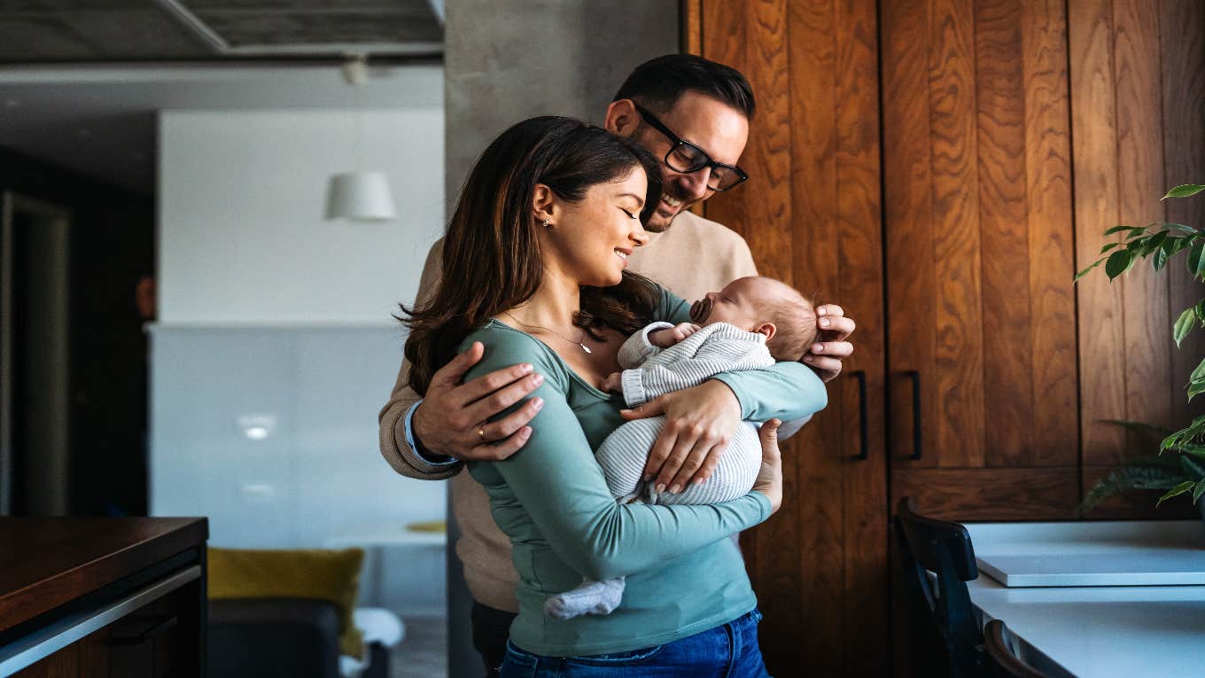 The Unspoken Truths About Becoming A Parent parents holding their baby