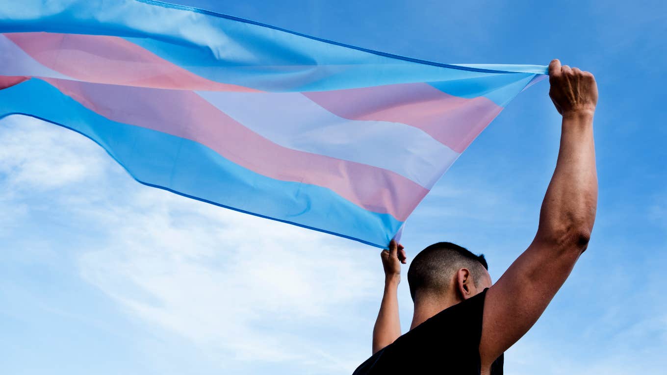 man with trans pride flag