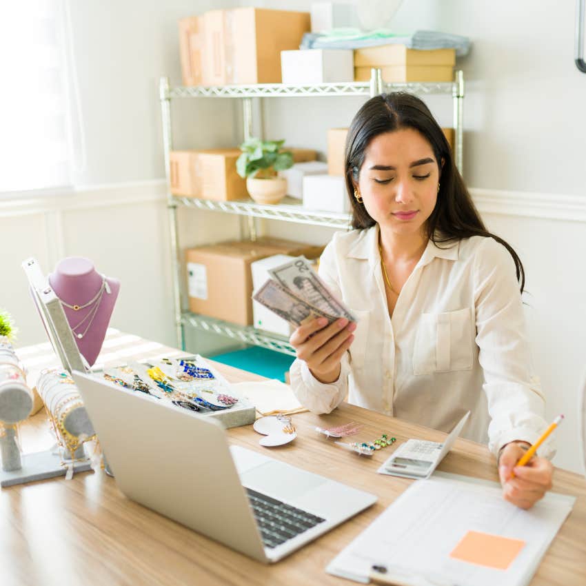 young woman counting money and doing finances