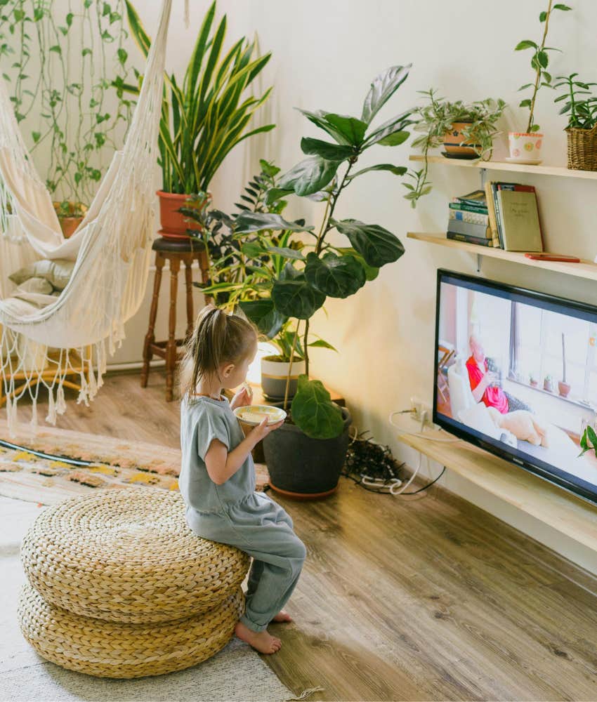 little girl eating and watching TV