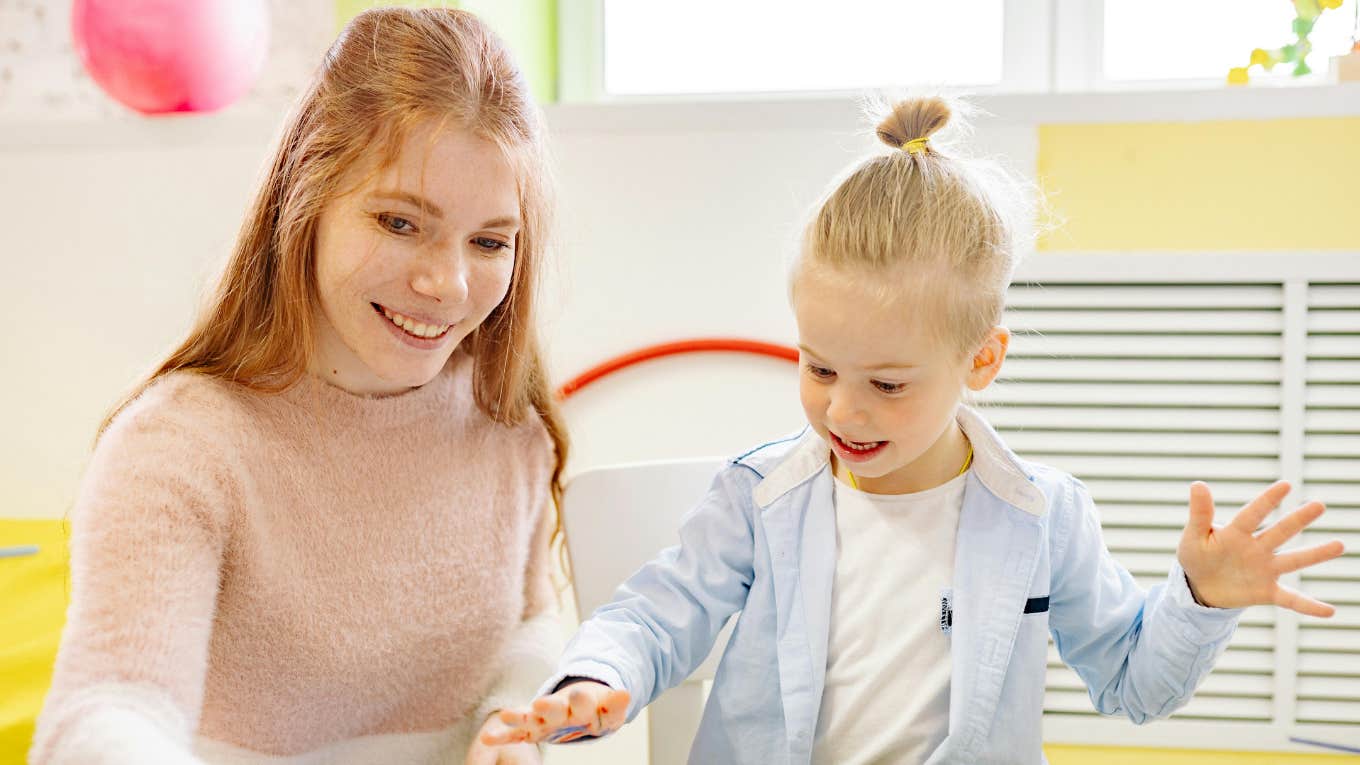 woman painting with child