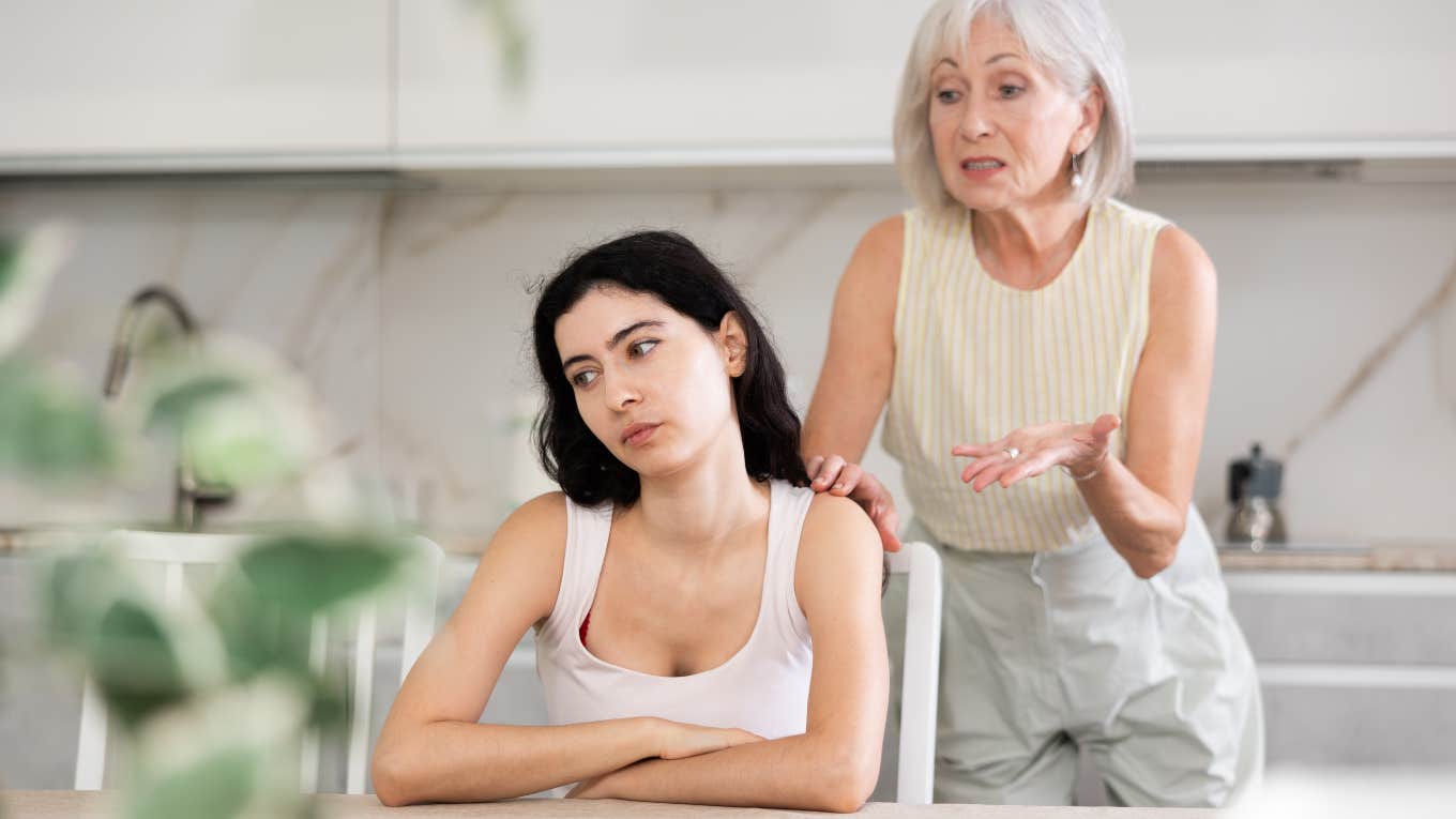 elderly woman trying to talk to angry younger woman