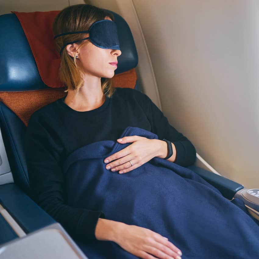 young woman sleeping in airplane.