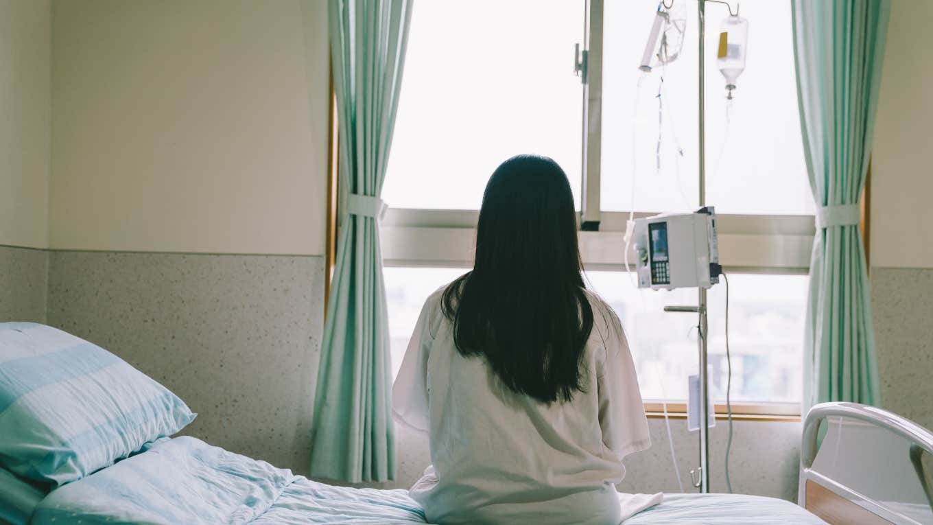 Women Have A Better Chance At Survival If Their Doctor Is Female woman sitting on hospital bed looking out window