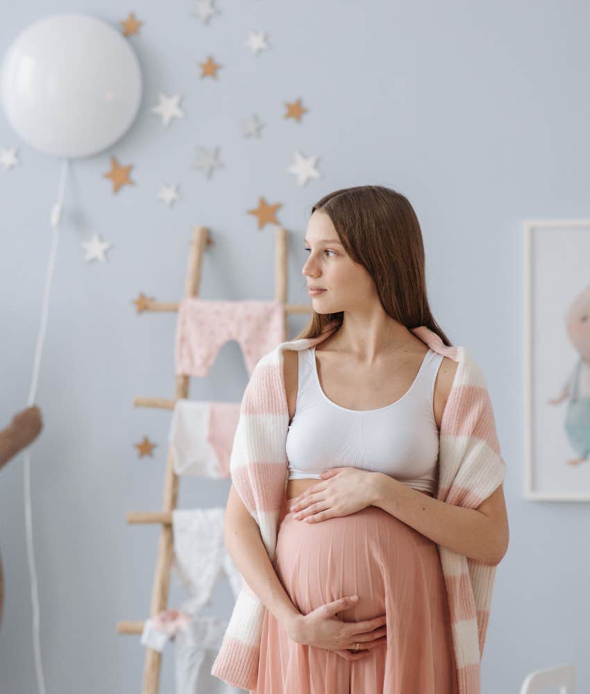 young pregnant girl holding belly