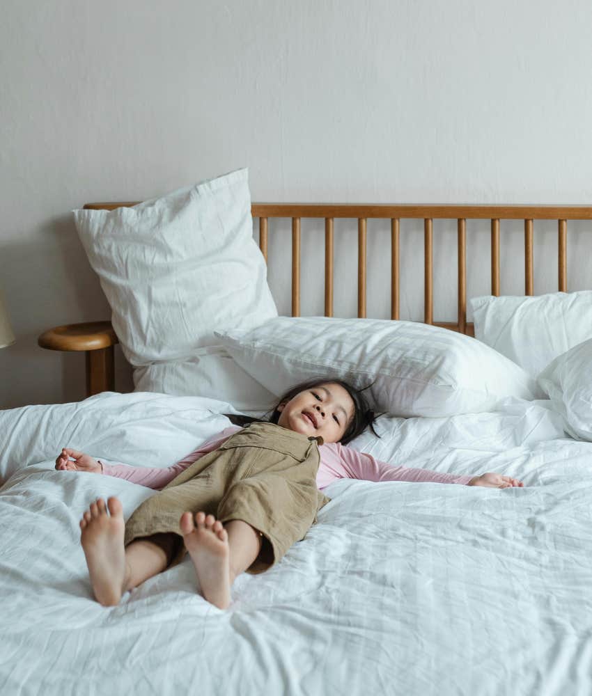 kid lying on a bed