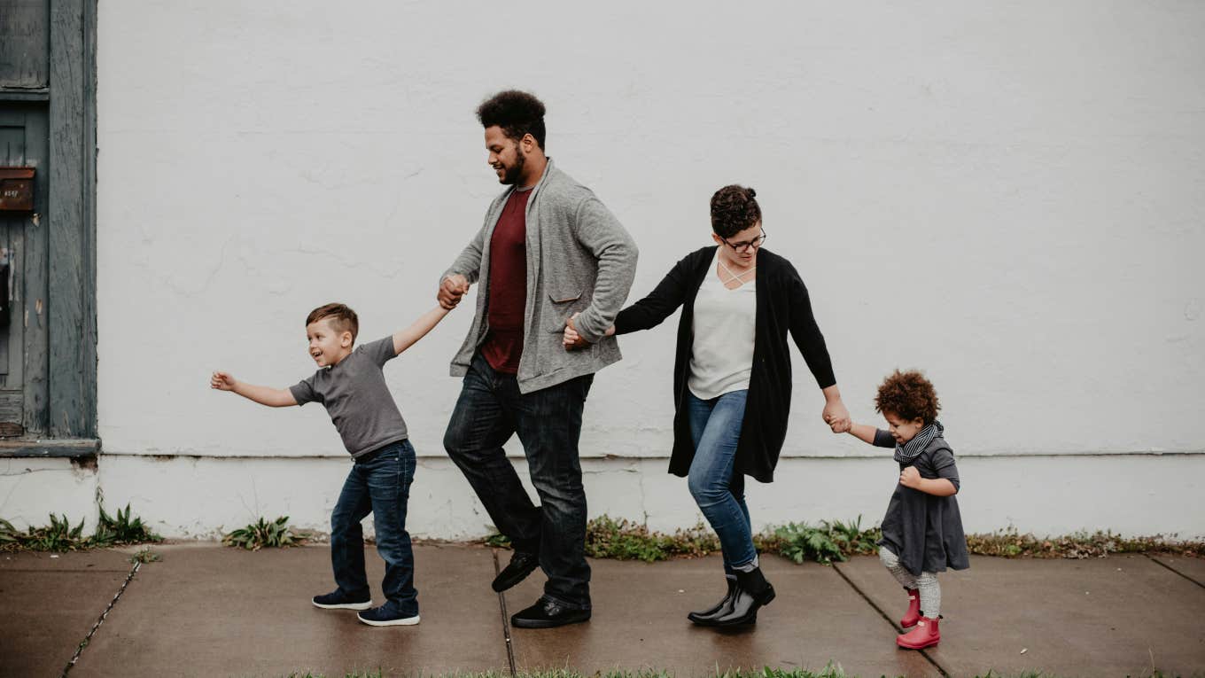 mom and dad walking with two kids