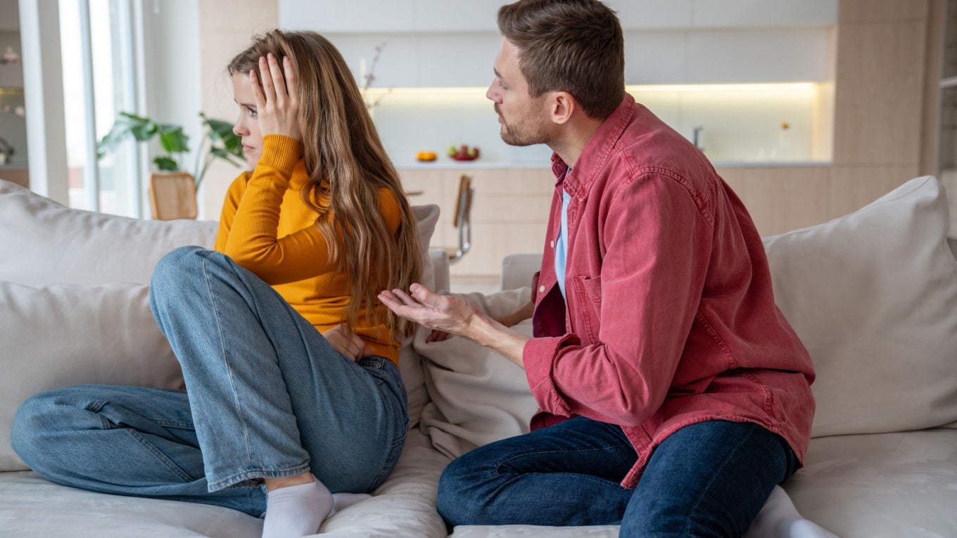 Displeased woman manipulator ignoring husband wanting to talk. Frustrated wife abuser creates toxic atmosphere in family couple. Domestic emotional stress, misunderstanding, relationship problems. Couple arguing on couch and one partner not listening.