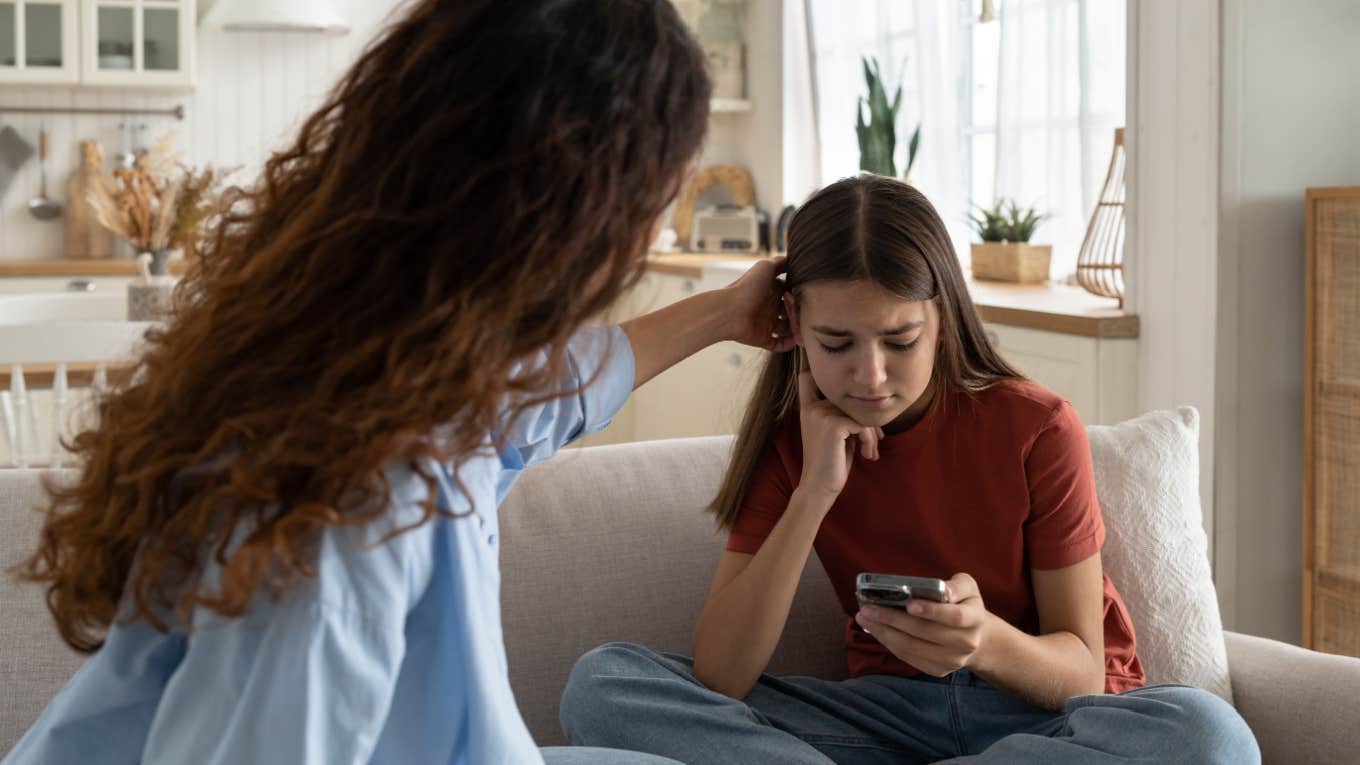 mom comforts teenage daughter after she gets fired