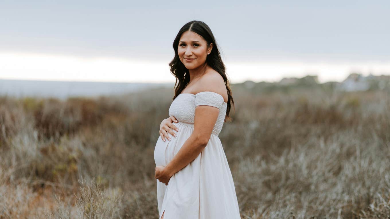 pregnant woman standing outside