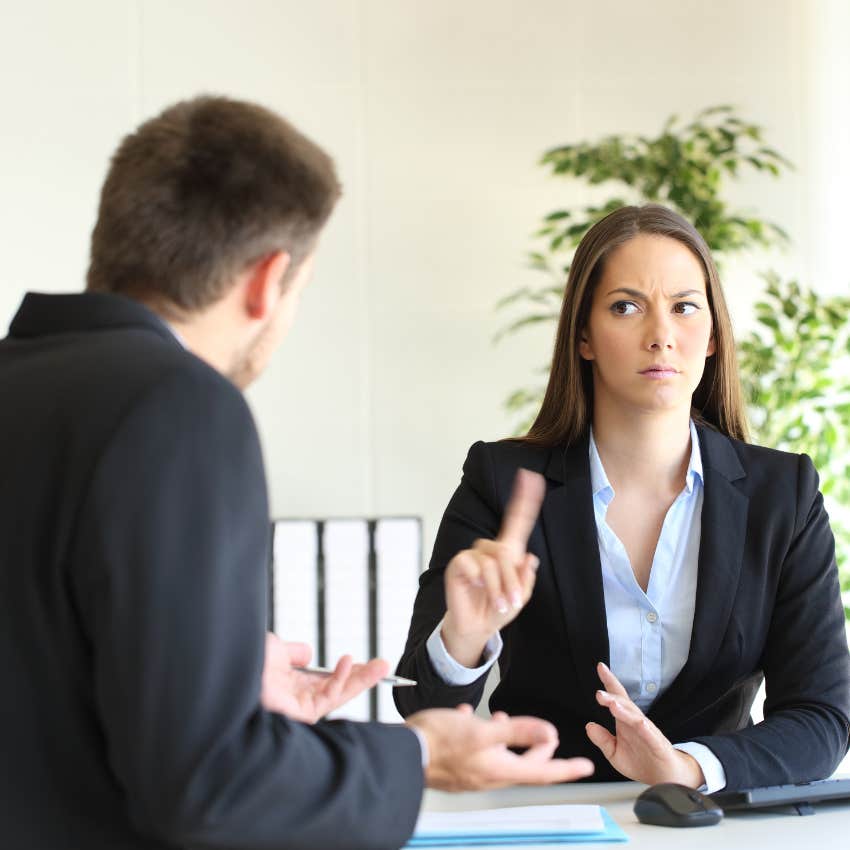 Angry boss having a discussion with a peer. 