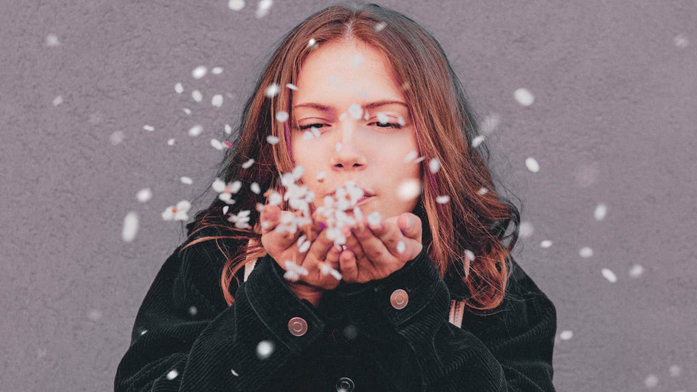 Avoidant Attachment Style: Definition, Causes & What To Do woman blowing paper