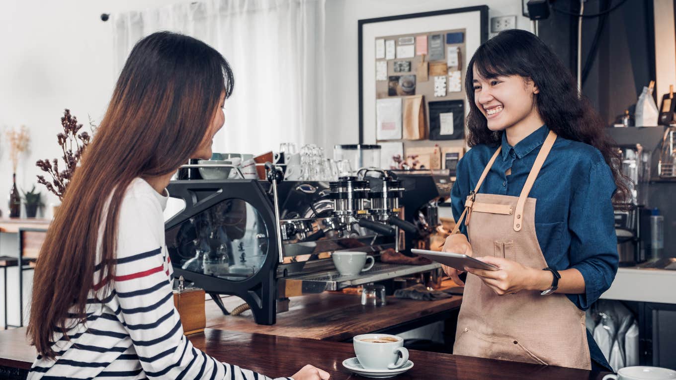 Barista Cries After Reading Note From Customer That Included A Tip To Help Bring Her Mom Home On Mother's Day Barista taking order from customer in coffee shop