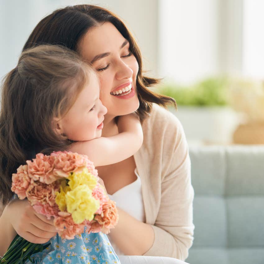 Little girl hugs her single mom. 
