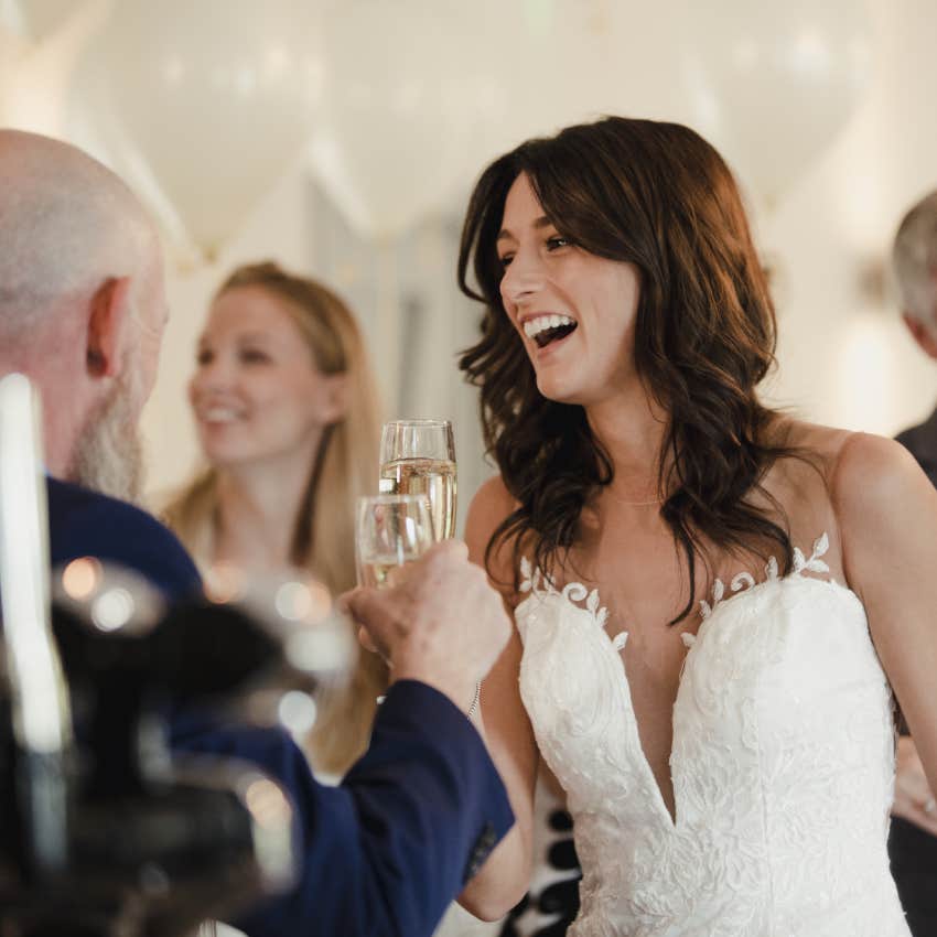 bride socializing with her father and family on her wedding day.