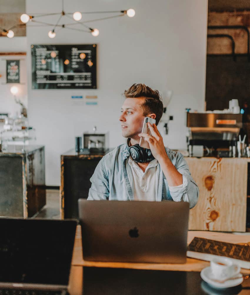 man with laptop talking on the phone