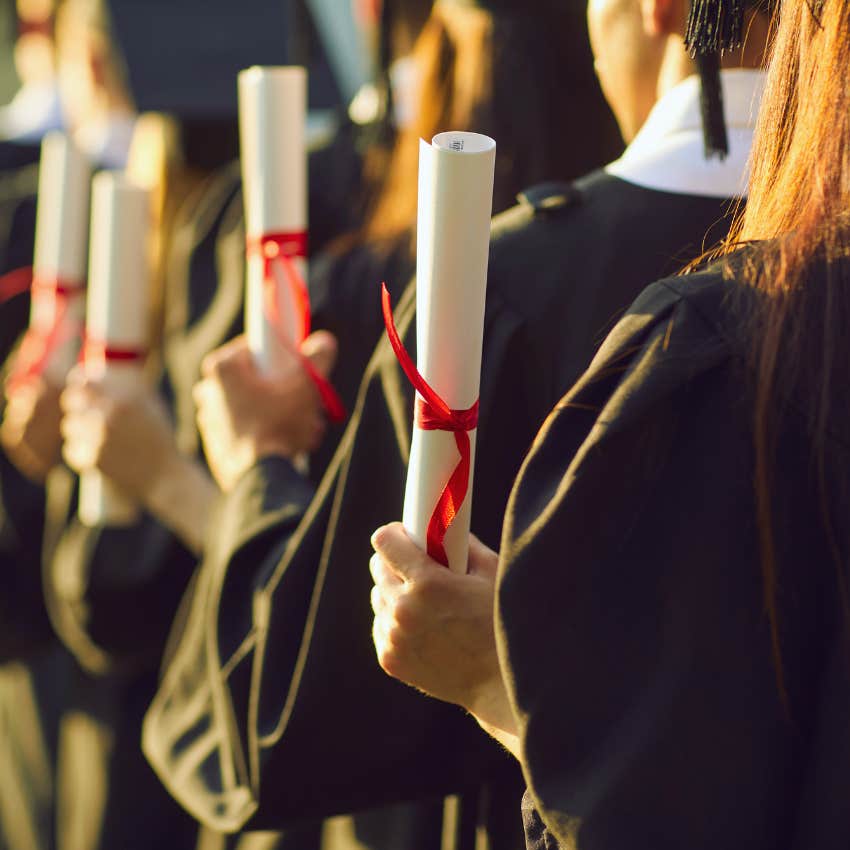 college graduates holding diplomas