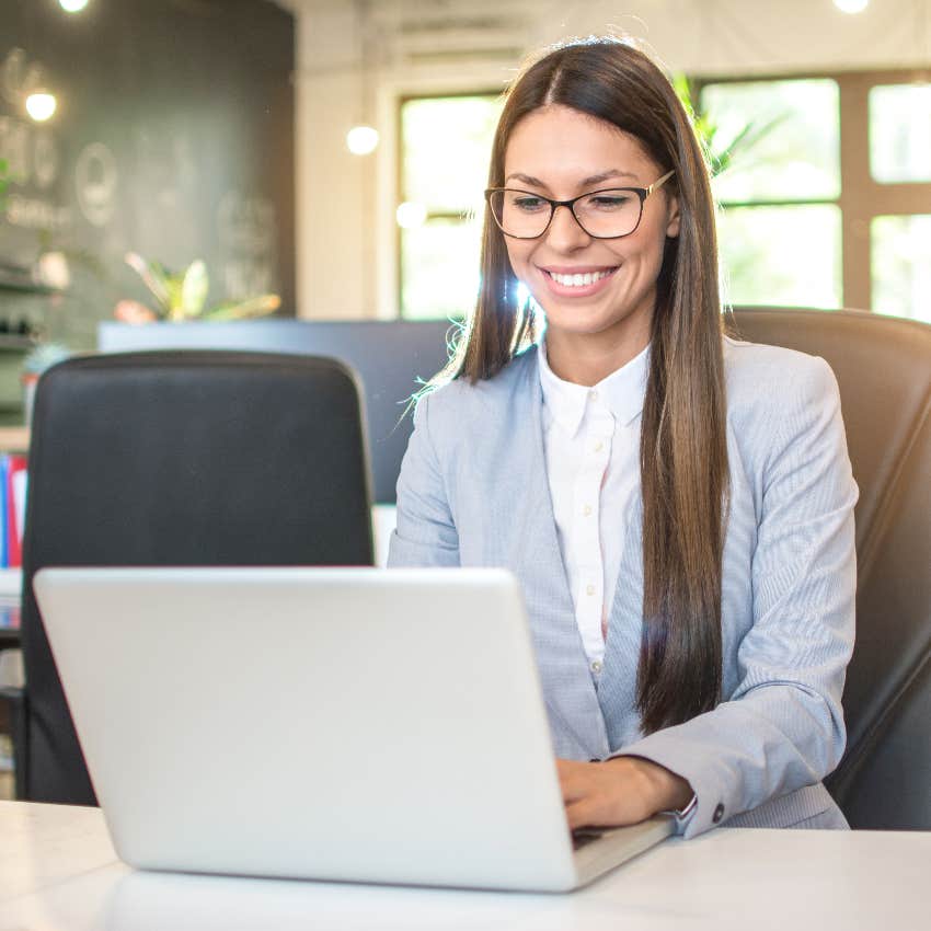 Confident woman emailing at work