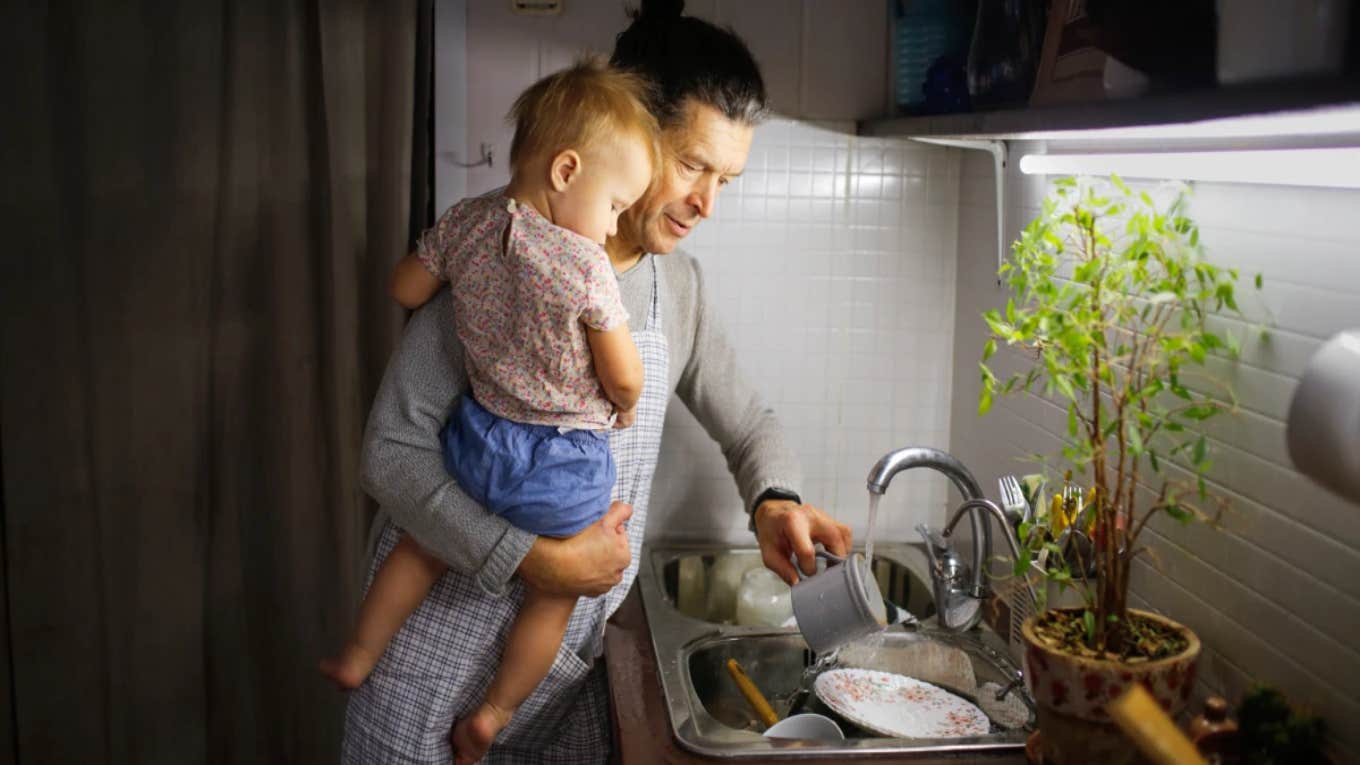 man holding son doing chores