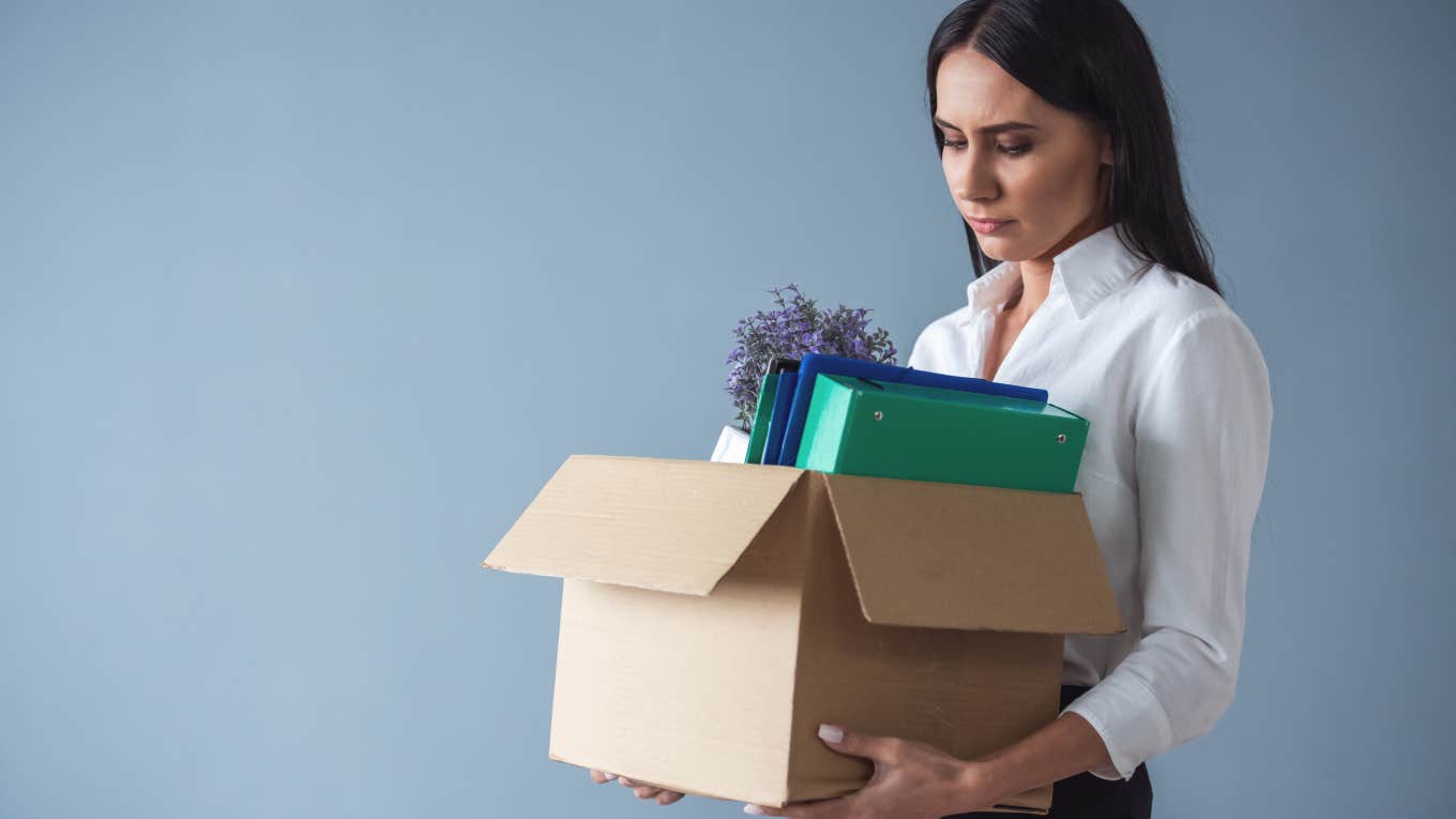 Employee Who Works Extra Time Fired For Poor Attendance businesswoman carrying out a box of her things after getting fired