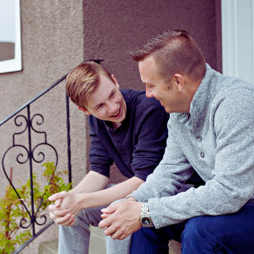 father and son having a talk on the front stoop