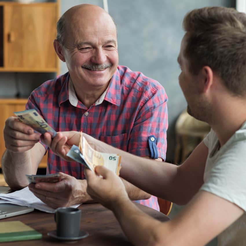 Father giving adult son money